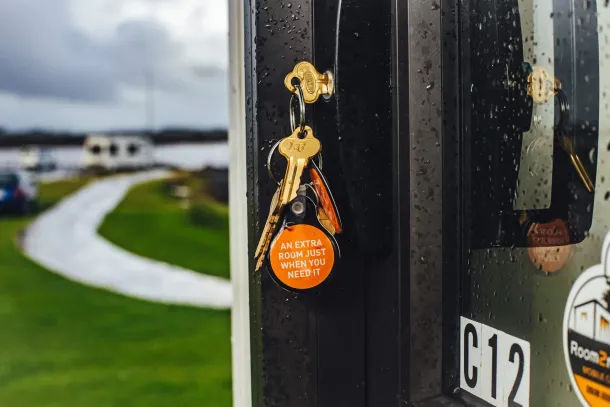 key hangs from a door handle, suggesting the door is either locked or ready to be opened - portable cabin rentals cost