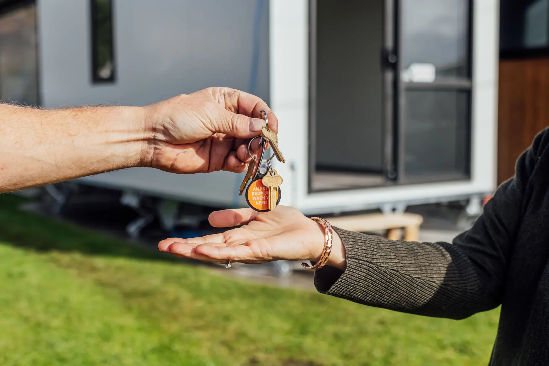 handing a key to another person, symbolizing the transfer of responsibility or access