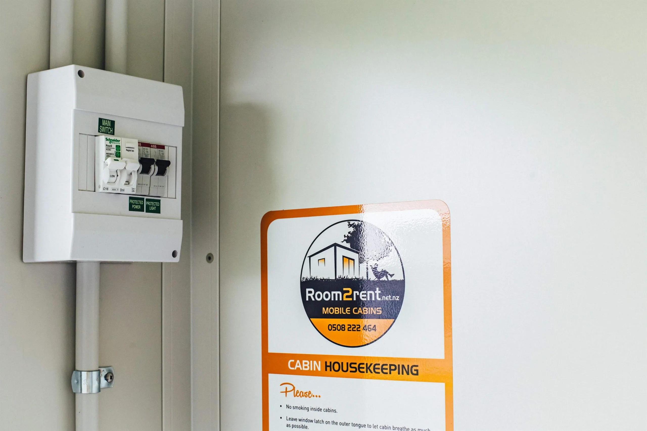 A white door featuring Room2Rent logo sign attached to it