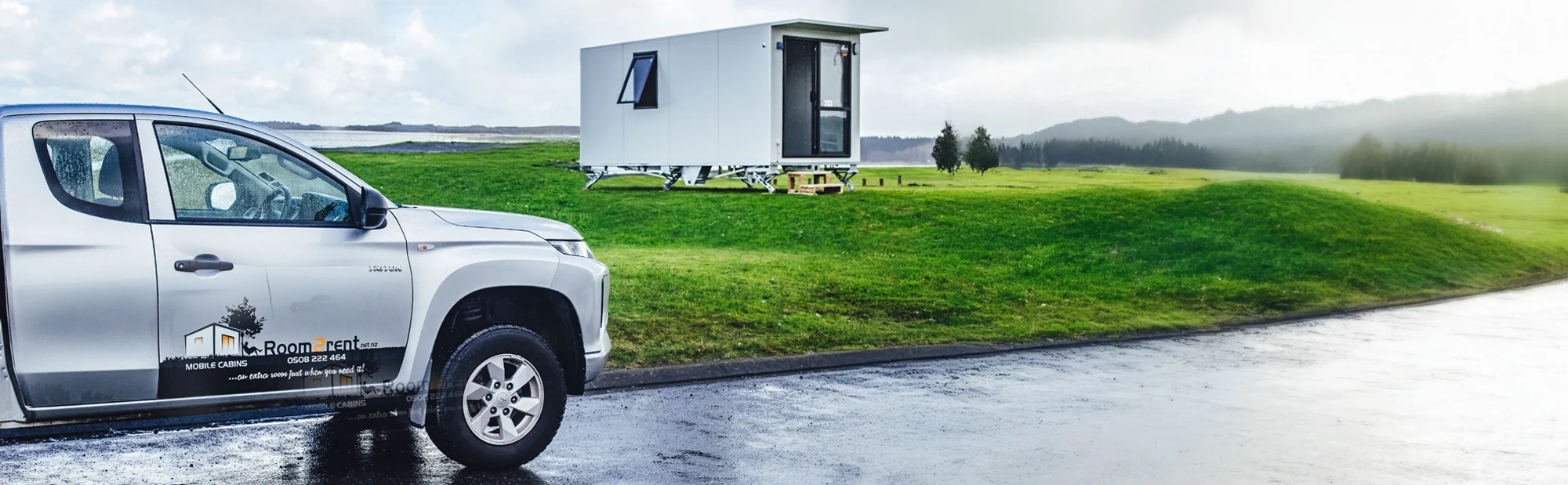 parked along the roadside, surrounded by grass and trees.