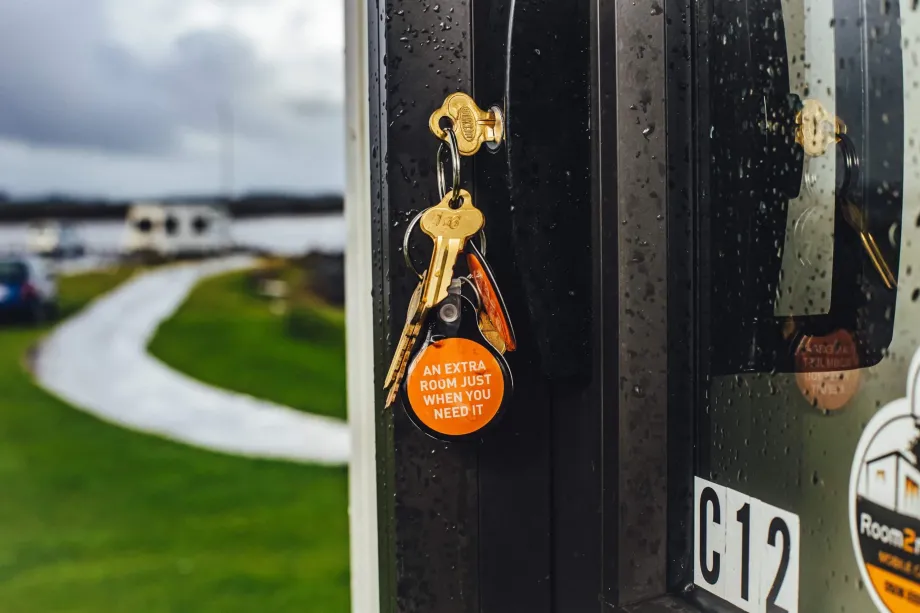 key hangs from a door handle, suggesting the door is either locked or ready to be opened - portable cabin rentals cost