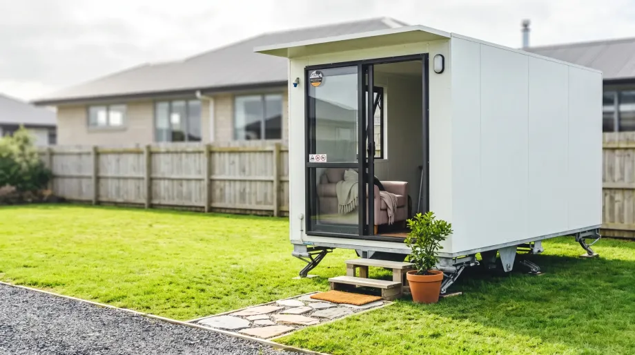 Portable cabin in a NZ backyard set up as a quiet client room.